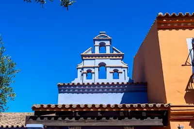 a clock tower on the side of a building at Apartahotel La Espadaña in Rota