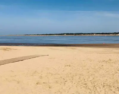 a sandy beach with the ocean in the background at Sanlúcar Playa de las Piletas in Sanlúcar de Barrameda