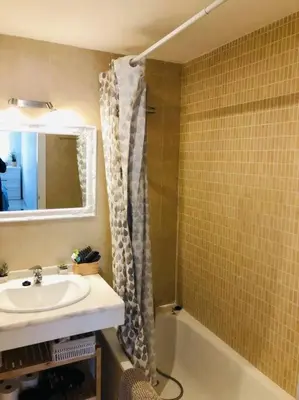 a bathroom with a sink and a bath tub at Sanlúcar Playa de las Piletas in Sanlúcar de Barrameda