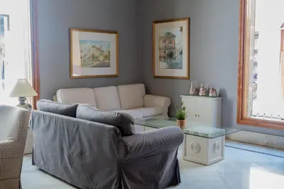 a living room with a couch and a table at Hotel Doña Blanca in Jerez de la Frontera