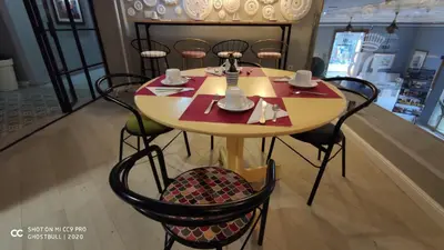 a table in a store with chairs and a table with cups at Hotel Doña Blanca in Jerez de la Frontera