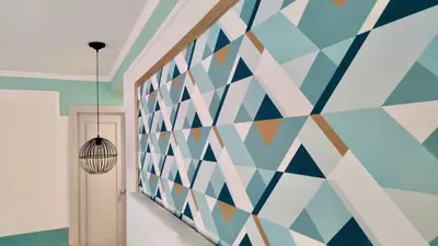 a hallway with a geometric mural on the wall at Hotel Doña Blanca in Jerez de la Frontera