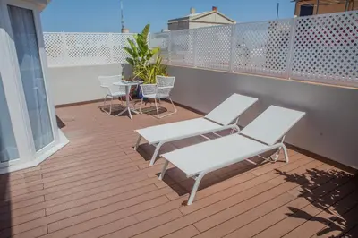 two white chairs and a table on a balcony at Hotel Doña Blanca in Jerez de la Frontera