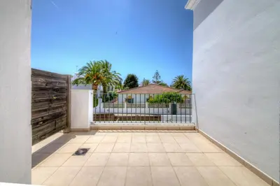 a view of a fence and a house at Apartamentos Piedramar in Conil de la Frontera