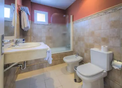 a bathroom with a toilet and a sink at Apartamentos Piedramar in Conil de la Frontera