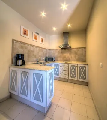 a kitchen with a sink and a counter top at Apartamentos Piedramar in Conil de la Frontera