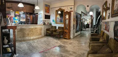 a lobby with chairs and a bar in a building at Hotel Nova Centro in Jerez de la Frontera