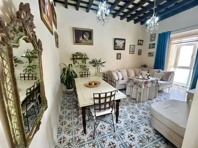 a living room with a table and a couch at GATU Casa Lola , 