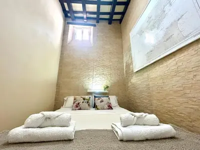 a bedroom with a bed with two pillows on it at GATU Casa Lola , 