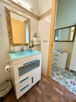 a bathroom with a sink and a mirror at GATU Casa Lola , 