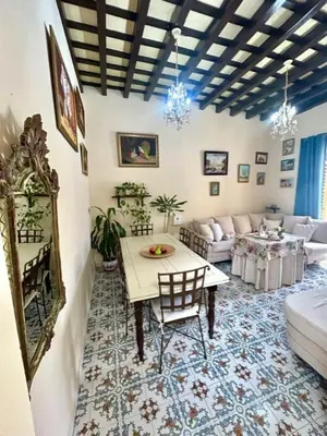 a living room with a table and a couch at GATU Casa Lola , 