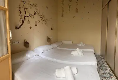 two beds in a room with white sheets and towels at GATU Casa Lola , 