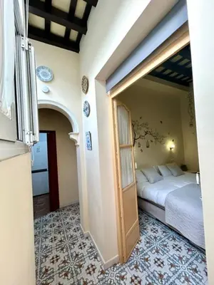 a bedroom with a bed and a door in a room at GATU Casa Lola , 