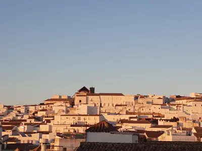 a group of people standing in front of a castle at Casa del Olivo by Casitasconencantoes in Medina Sidonia