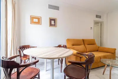 a living room with a table and a couch at Allo Apartments Porvenir Centro 1 Habitación in Jerez de la Frontera