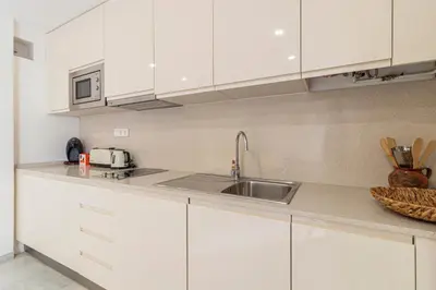 a kitchen with white cabinets and a sink at Allo Apartments Porvenir Centro 1 Habitación in Jerez de la Frontera