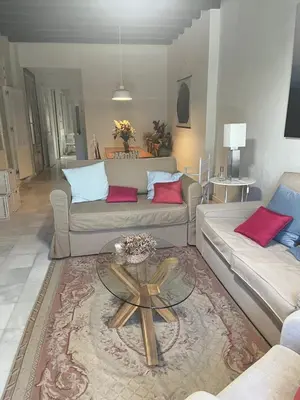 a living room with two couches and a coffee table at Jardin Bizcocheros in Jerez de la Frontera