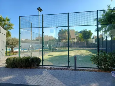 a tennis court with a net on a tennis court at Atico Costa Doñana in Sanlúcar de Barrameda