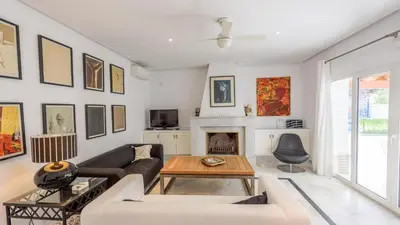 a living room with a couch and a fireplace at Villa con Encanto Conil de la Frontera by Ruralidays in Conil de la Frontera