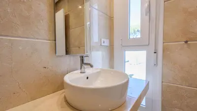 a bathroom with a white sink and a mirror at Villa con Encanto Conil de la Frontera by Ruralidays in Conil de la Frontera
