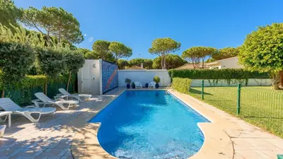 a swimming pool in a backyard with chairs and a fence at Villa con Encanto Conil de la Frontera by Ruralidays in Conil de la Frontera