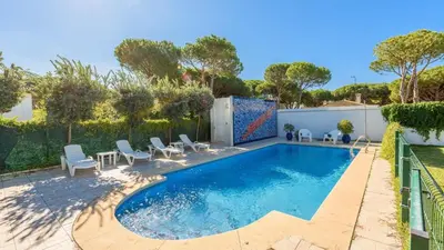a swimming pool in a backyard with chairs and a fence at Villa con Encanto Conil de la Frontera by Ruralidays in Conil de la Frontera