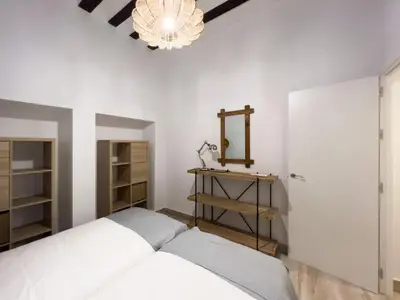 a bedroom with two beds and a mirror at El Destino Corazón de Cádiz Grupo AC Gestion in Cádiz