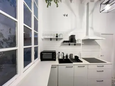a white kitchen with a sink and a microwave at El Destino Corazón de Cádiz Grupo AC Gestion in Cádiz