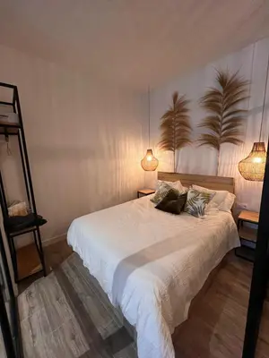a bedroom with a large white bed with two lamps at Loft Deluxe Herrería 6 - Vivienda Vacacional. in El Puerto de Santa María