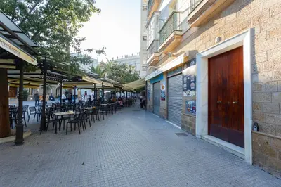 an empty street with tables and chairs and a building at SERENISSIMA Apartment by Cadiz4Rentals in Cádiz
