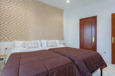 a bedroom with a large bed with a wall at SERENISSIMA Apartment by Cadiz4Rentals in Cádiz