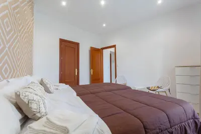 a bedroom with a large bed with a brown blanket at SERENISSIMA Apartment by Cadiz4Rentals in Cádiz