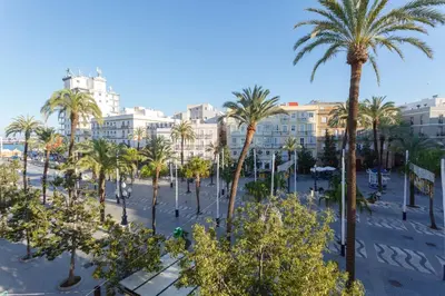 a view of a city with palm trees and buildings at SERENISSIMA Apartment by Cadiz4Rentals in Cádiz