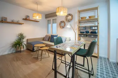 a living room with a table and a couch at Apartamento La Habanera de Cadiz in Cádiz