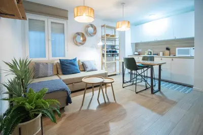 a living room with a couch and a kitchen at Apartamento La Habanera de Cadiz in Cádiz
