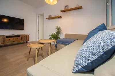 a living room with a couch and a tv at Apartamento La Habanera de Cadiz in Cádiz