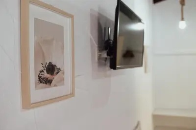 a framed picture on a wall next to a mirror at APARTAMENTO EL NANO in Jerez de la Frontera