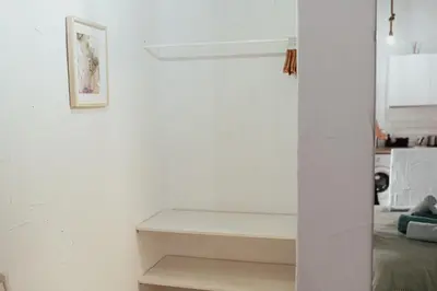a white room with a bed and a white wall at APARTAMENTO EL NANO in Jerez de la Frontera