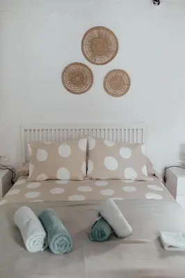 a bedroom with a bed with pillows on it at APARTAMENTO EL NANO in Jerez de la Frontera