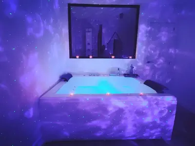 a bathroom with a bath tub with purple lighting at Amores Loft Rural in Alcalá de los Gazules
