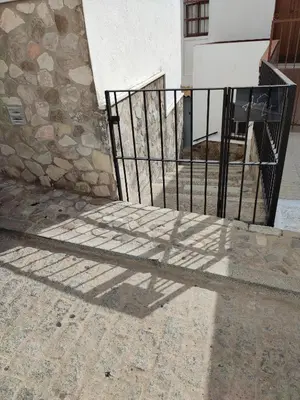 a shadow of a gate on the floor of a building at Amores Loft Rural in Alcalá de los Gazules