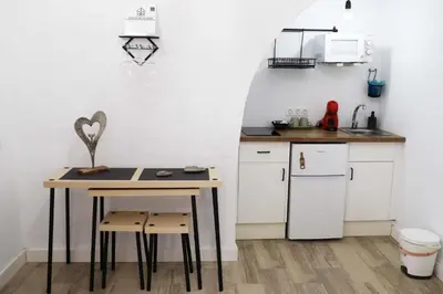 a small kitchen with a table and a counter at Amores Loft Rural in Alcalá de los Gazules
