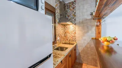 a kitchen with a sink and a bowl of fruit on the counter at Apto El Descanso I Conil de la Frontera by Ruralidays in Conil de la Frontera