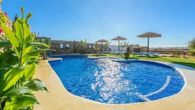 a pool with blue water in a yard at Apto El Descanso I Conil de la Frontera by Ruralidays in Conil de la Frontera