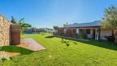 a backyard of a house with a grass yard at Apto El Descanso I Conil de la Frontera by Ruralidays in Conil de la Frontera