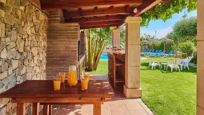 a wooden table with glasses of orange juice on it at Apto El Descanso III Conil de la Frontera by Ruralidays in Conil de la Frontera