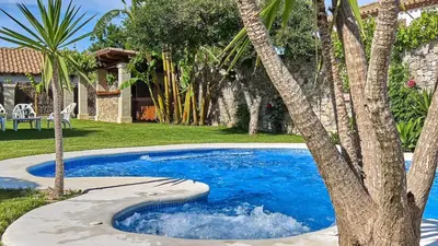 a swimming pool with a tree in a yard at Apto El Descanso III Conil de la Frontera by Ruralidays in Conil de la Frontera