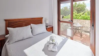 a bedroom with a bed with a towel on it at Apto El Descanso III Conil de la Frontera by Ruralidays in Conil de la Frontera