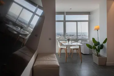 a living room with a couch and a table at Apartamento La Atalaya de Cádiz in Cádiz