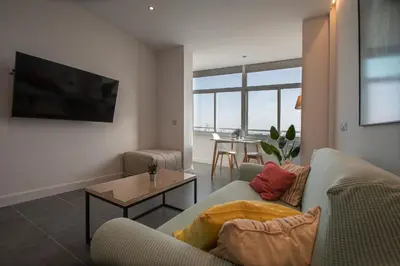 a living room with a couch and a table at Apartamento La Atalaya de Cádiz in Cádiz